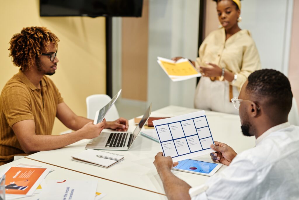 Startup Spotlight: Entrepreneurial Journeys and Growth Entrepreneurial team working together on an advanced product launch model inside a modern workspace.